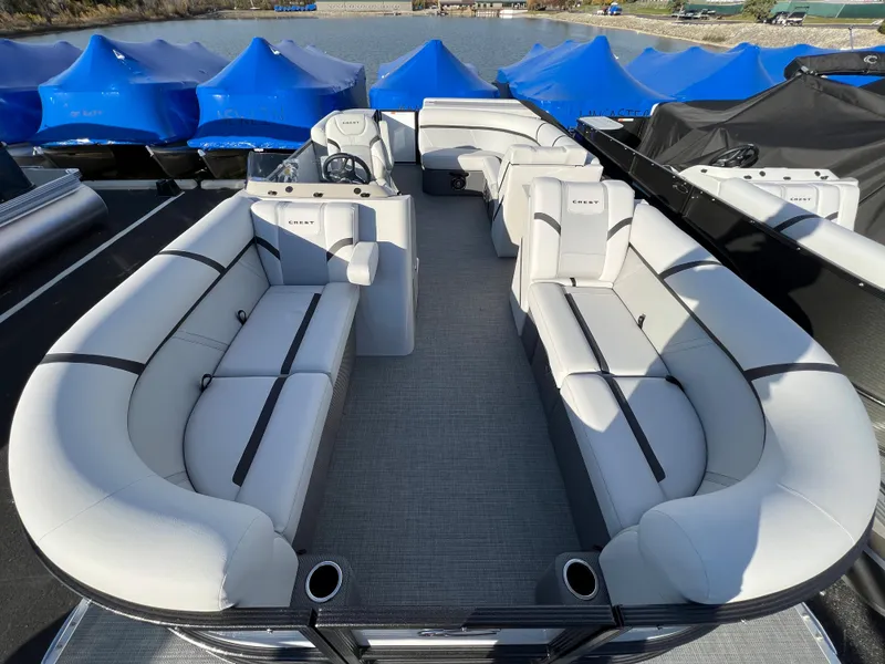 Slide: The Image of 2024 Crest Classic LX 220 pontoon boat with spacious seating and modern design. - 3