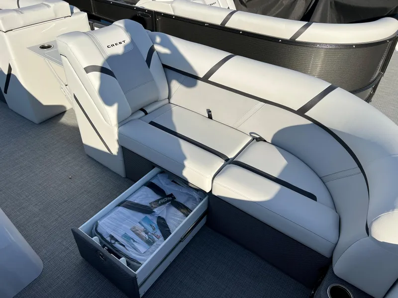 Slide: The Image of 2024 Crest Classic LX 220 boat interior with storage compartment open. - 6