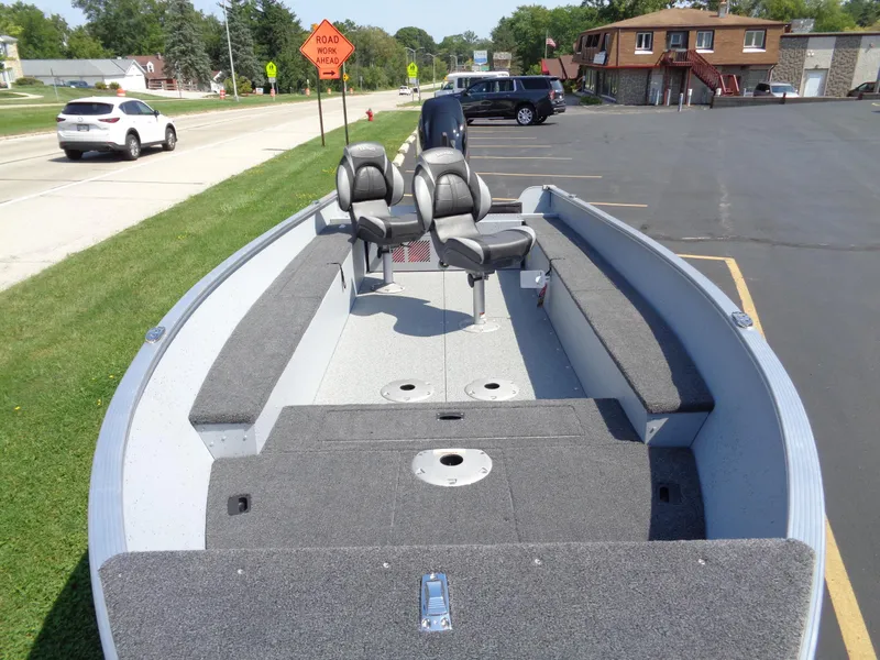 Slide: The Image of 2024 Lund 1600 Fury Tiller boat interior with seating and storage compartments. - 1