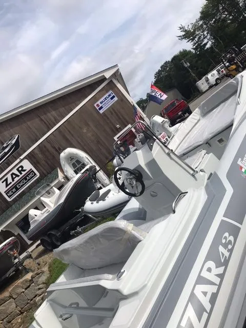 Slide: The Image of 2024 Zar Formenti 43 boat on a trailer in a sunny outdoor setting. - 1