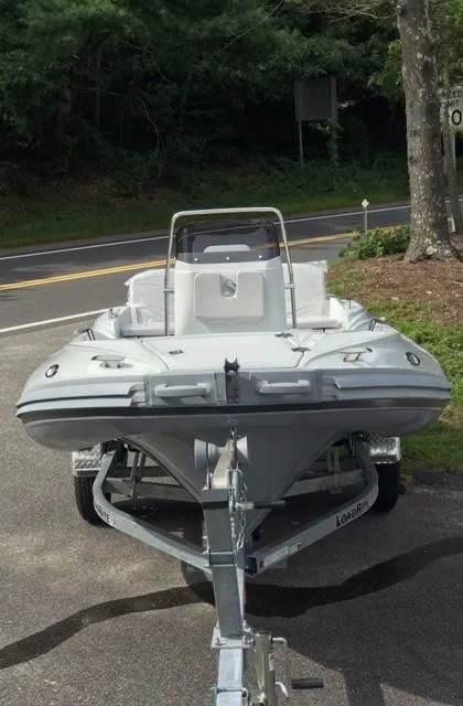 Slide: The Image of 2024 Zar Formenti 43 boat displayed outdoors near a garage and trees. - 5