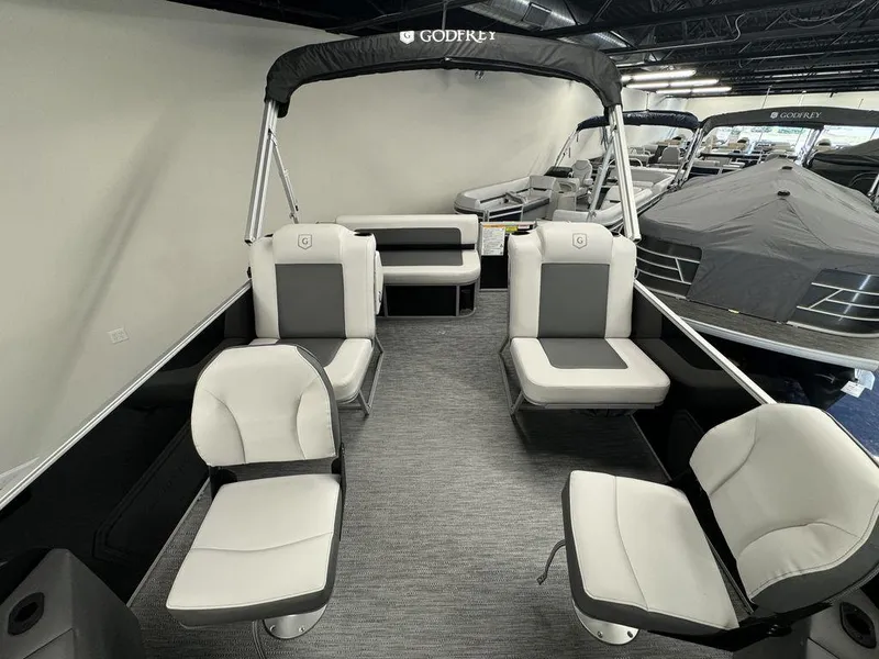 Slide: The Image of 2024 Godfrey MG 1476 F pontoon boat interior with gray and white seating. - 2