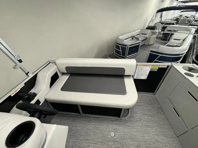 Slide: The Image of 2024 Godfrey MG 1476 F pontoon boat interior with seating and storage compartments. - 3