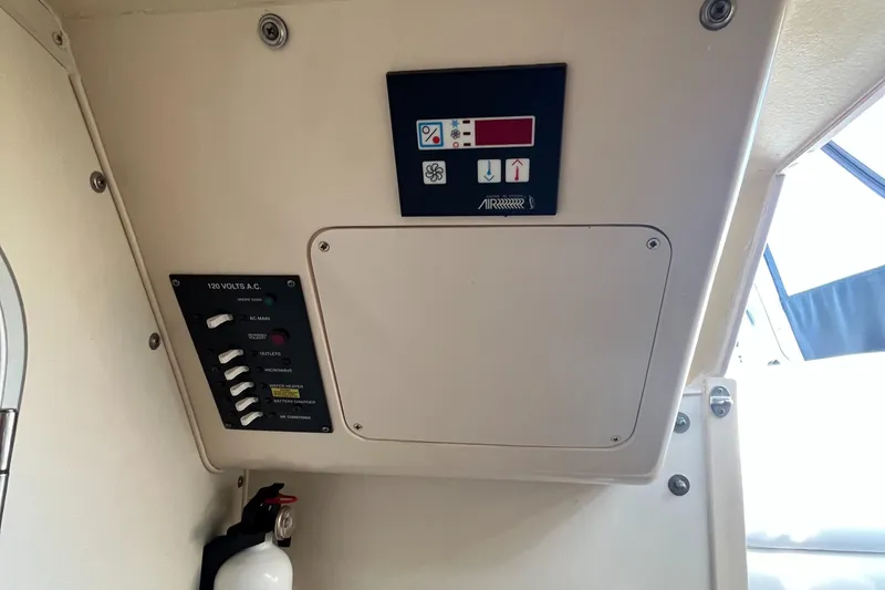 Slide: The Image of Grady-White 282 Sailfish, 110v AC breaker panel and Heat/AC Controls - 30