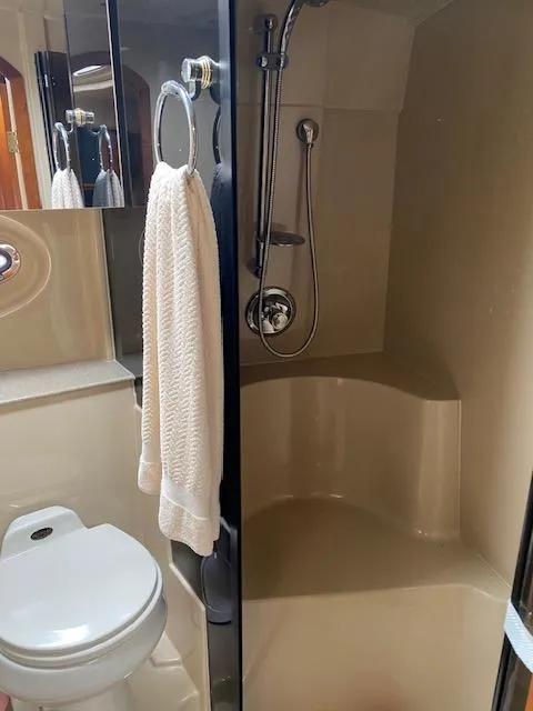 Slide: The Image of 2003 Cruisers Yachts 3772 Express bathroom with shower, toilet, and towel. - 10