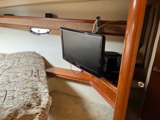 Slide: The Image of 2003 Cruisers Yachts 3772 Express cabin with TV and bed. - 16