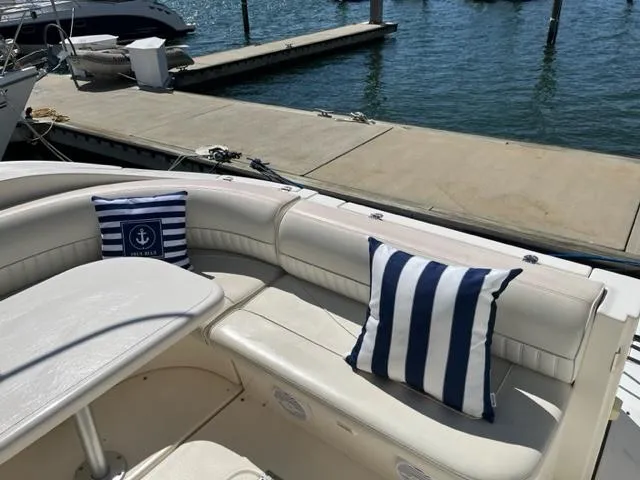 Slide: The Image of 2003 Cruisers Yachts 3772 Express boat with striped cushions docked at marina. - 18