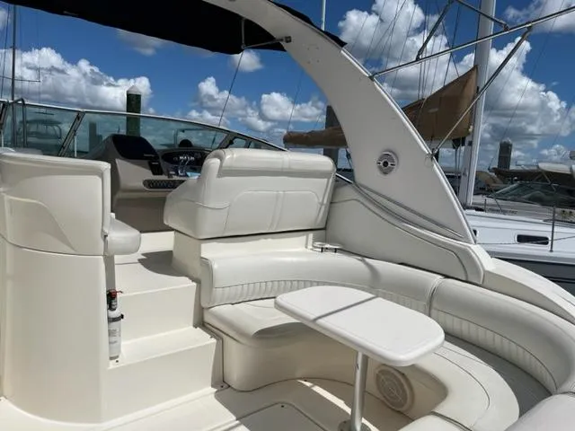 Slide: The Image of 2003 Cruisers Yachts 3772 Express boat interior with white seating and table. - 23