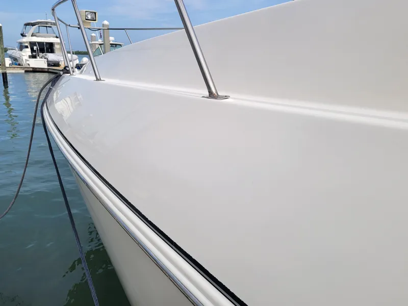 Slide: The Image of 2003 Cruisers Yachts 3772 Express docked at marina, side view. - 3