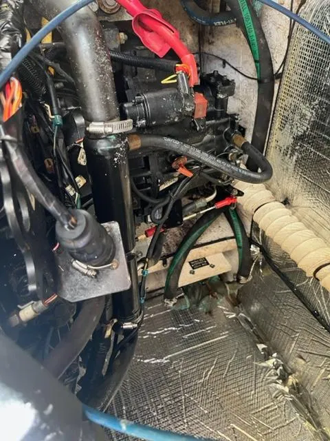 Slide: The Image of Engine compartment of a 2003 Cruisers Yachts 3772 Express with various mechanical components. - 30