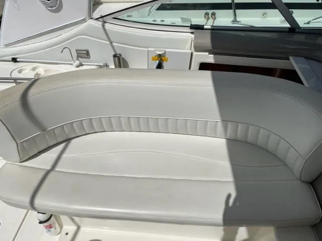 Slide: The Image of 2003 Cruisers Yachts 3772 Express white leather seating area on deck. - 32