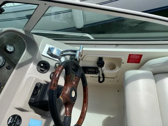 Slide: The Image of 2003 Cruisers Yachts 3772 Express helm with wood steering wheel and control panel. - 37