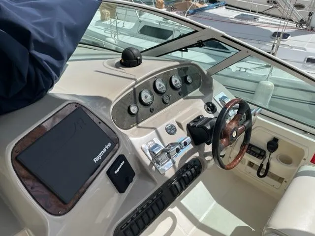 Slide: The Image of 2003 Cruisers Yachts 3772 Express helm with Raymarine electronics and wood-accented steering wheel. - 39