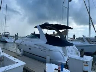 Slide: The Image of 2003 Cruisers Yachts 3772 Express docked at a marina under a cloudy sky. - 9