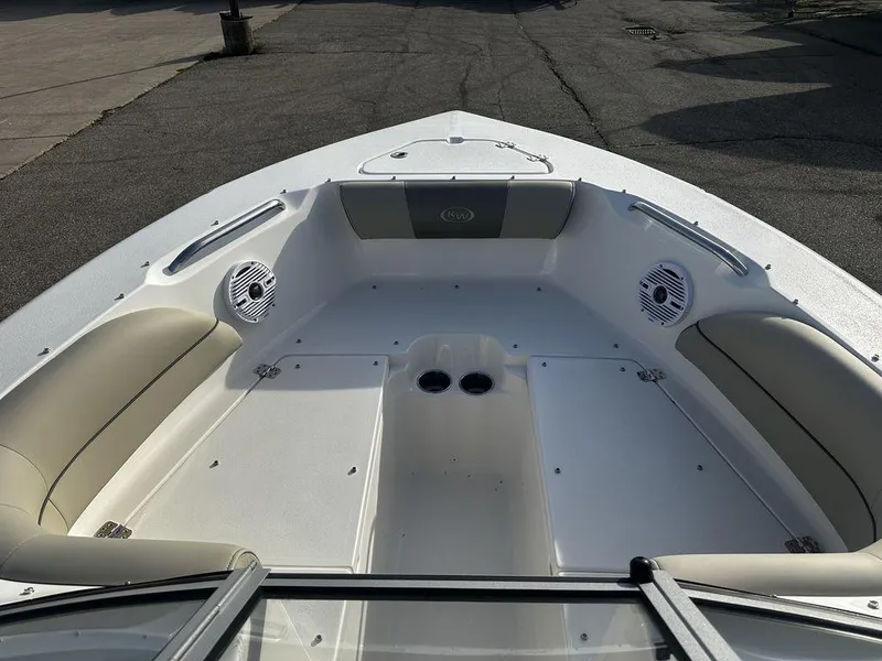 Slide: The Image of 2024 Key West 203 DFS boat interior with cushioned seating and built-in speakers. - 2