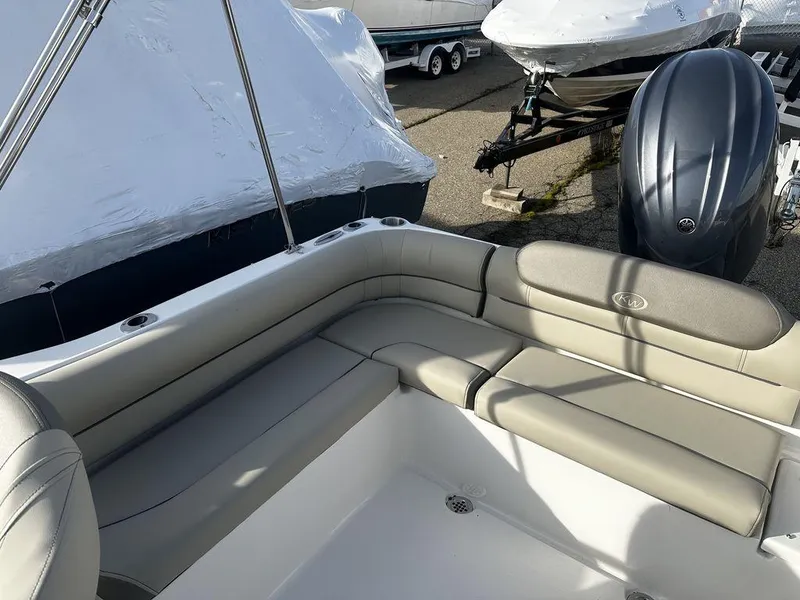 Slide: The Image of 2024 Key West 203 DFS boat interior with cushioned seating and outboard motor. - 3
