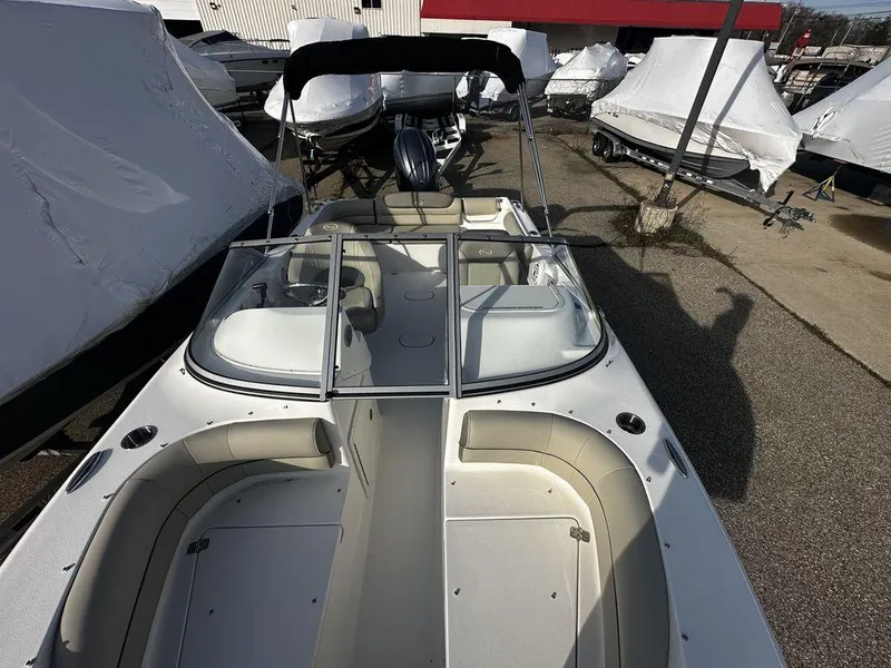 Slide: The Image of 2024 Key West 203 DFS boat with seating and windshield, displayed in a marina. - 8