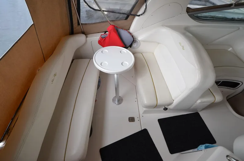 Slide: The Image of Interior seating area of 2003 Sea Ray 280 DA boat with table and cushions. - 11