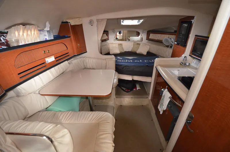 Slide: The Image of Interior of 2003 Sea Ray 280 DA boat with dining area, kitchenette, and sleeping quarters. - 12