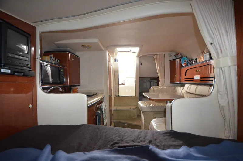 Slide: The Image of Interior of 2003 Sea Ray 280 DA boat with kitchen and seating area. - 15