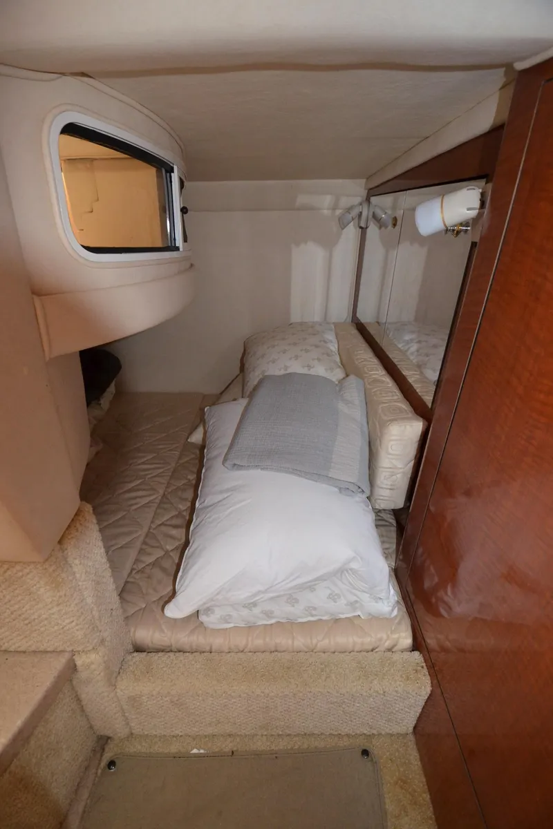 Slide: The Image of Interior cabin of a 2003 Sea Ray 280 DA boat with bed and pillows. - 19