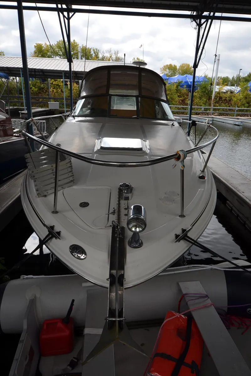 Slide: The Image of 2003 Sea Ray 280 DA boat docked in a covered marina. - 2
