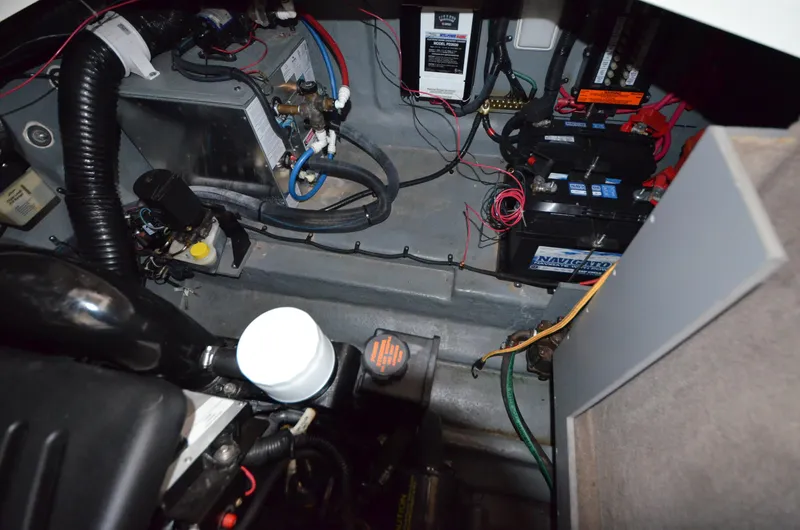 Slide: The Image of Engine compartment of a 2003 Sea Ray 280 DA boat with visible wiring and components. - 21