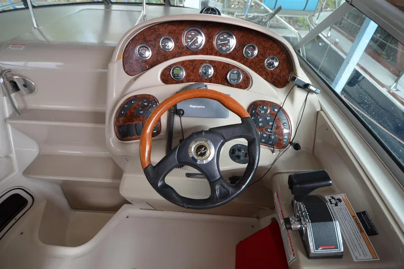 Slide: The Image of Cockpit of 2003 Sea Ray 280 DA with woodgrain dashboard and steering wheel. - 4