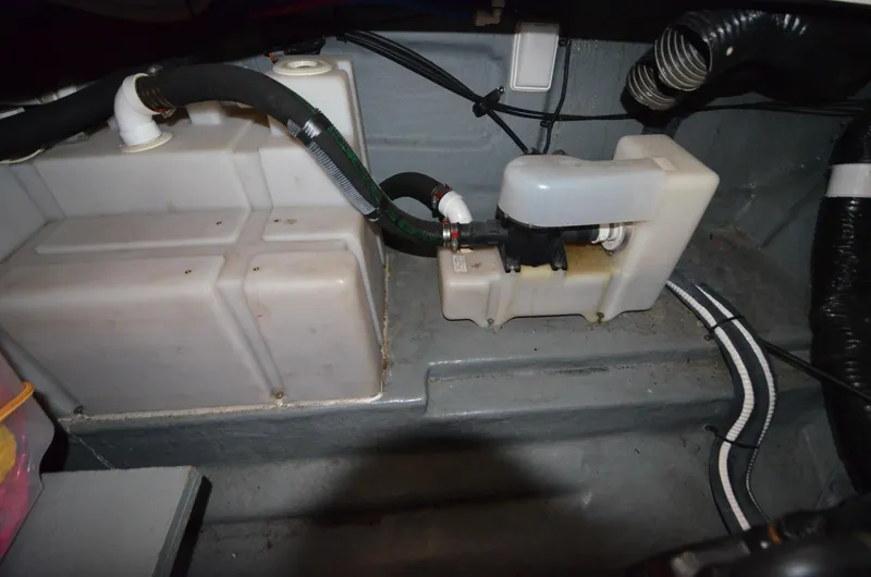 Slide: The Image of 2003 Sea Ray 280 DA engine compartment with water tanks and hoses. - 7