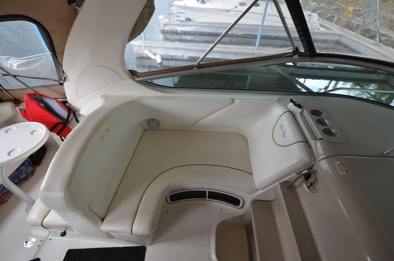 Slide: The Image of 2003 Sea Ray 280 DA boat interior with white seating and dashboard. - 8