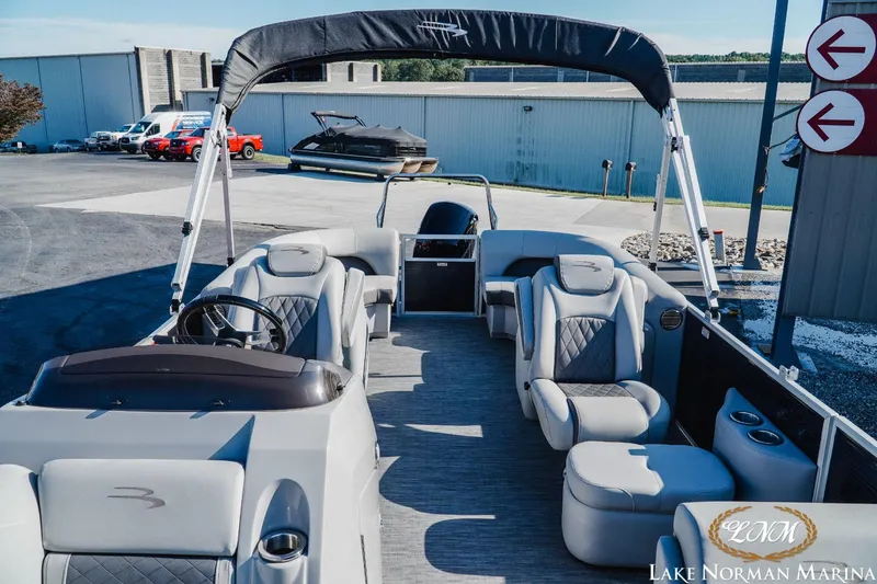 Slide: The Image of 2023 Bennington 23LSR pontoon boat at Lake Norman Marina, featuring spacious seating and modern design. - 14