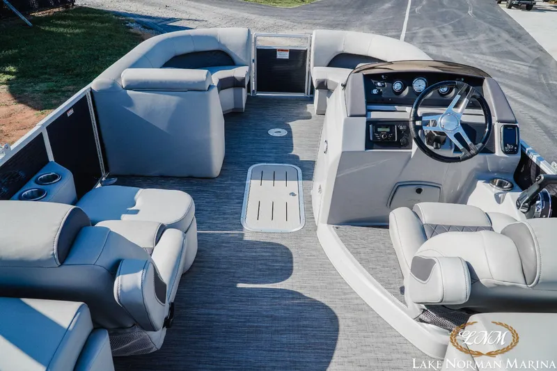 Slide: The Image of 2023 Bennington 23LSR pontoon boat interior with plush seating and modern helm. - 9