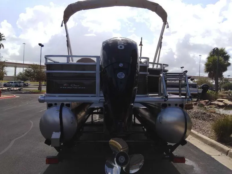 Slide: The Image of 2024 Sun Tracker SportFish 22 DLX pontoon boat rear view with outboard motor. - 3