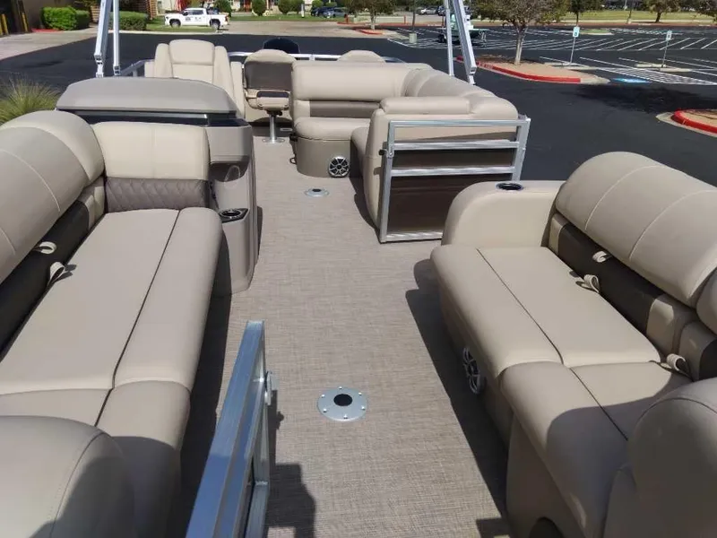 Slide: The Image of 2024 Sun Tracker SportFish 22 DLX pontoon boat with spacious seating and modern design. - 4