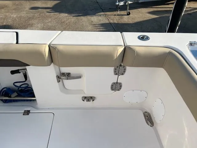 Slide: The Image of 2020 Tidewater 320 CC Adventure boat interior with cushioned seating and storage compartments. - 10