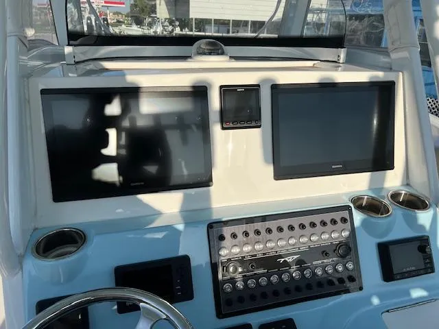 Slide: The Image of Control panel of a 2020 Tidewater 320 CC Adventure boat with dual screens. - 13