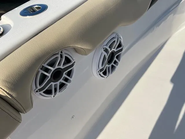 Slide: The Image of Close-up of 2020 Tidewater 320 CC Adventure boat speakers and cushioned seating. - 17
