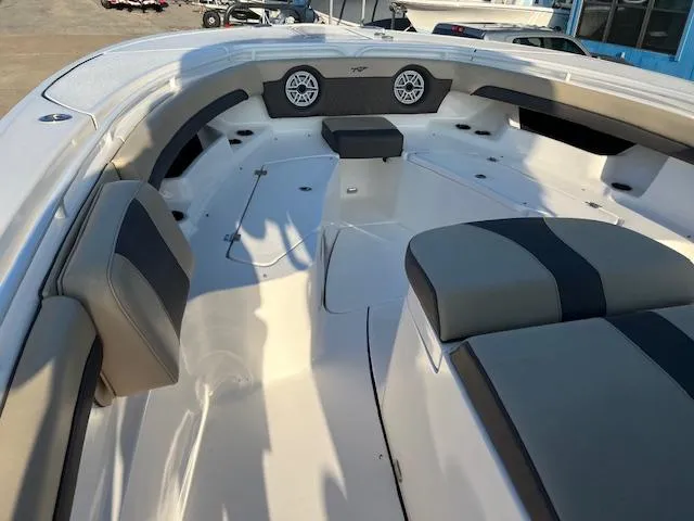 Slide: The Image of 2020 Tidewater 320 CC Adventure boat interior with cushioned seating and speakers. - 18