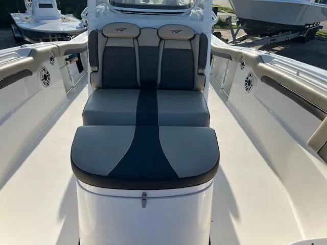 Slide: The Image of 2020 Tidewater 320 CC Adventure boat seating area with cushioned seats. - 20