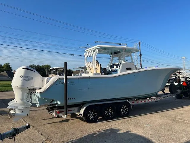 Slide: The Image of 2020 Tidewater 320 CC Adventure boat on trailer with twin Yamaha engines. - 3