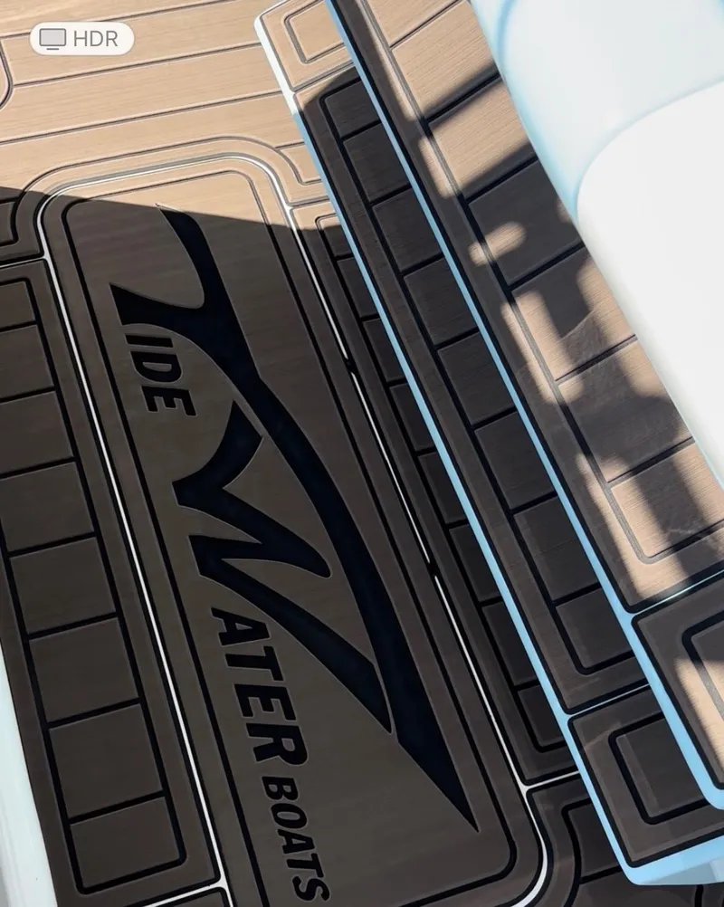 Slide: The Image of 2020 Tidewater 320 CC Adventure boat deck with logo and sleek design. - 6