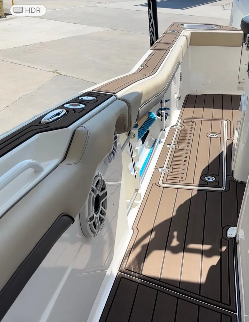 Slide: The Image of 2020 Tidewater 320 CC Adventure boat interior with cushioned seating and teak-style flooring. - 8