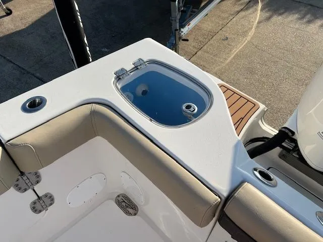 Slide: The Image of 2020 Tidewater 320 CC Adventure boat interior with livewell and cushioned seating. - 9