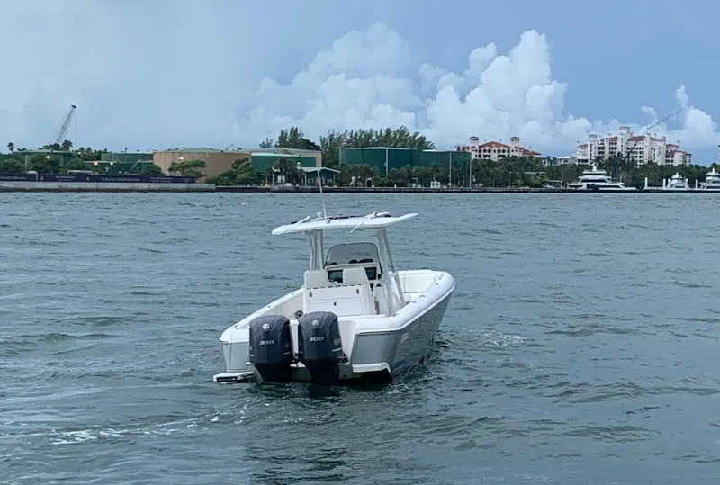 Slide: The Image of 2012 Intrepid 327 Center Console boat on water with twin 300 HP engines. - 10