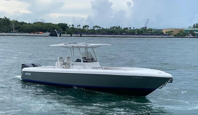 Slide: The Image of 2012 Intrepid 327 Center Console boat on the water with a scenic background. - 4