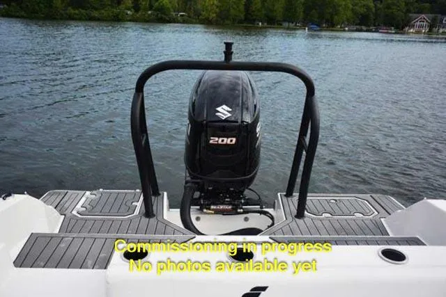 Slide: The Image of 2024 Starcraft SVX 211 OB boat commissioning in progress, rear view with Suzuki 200 outboard motor. - 10