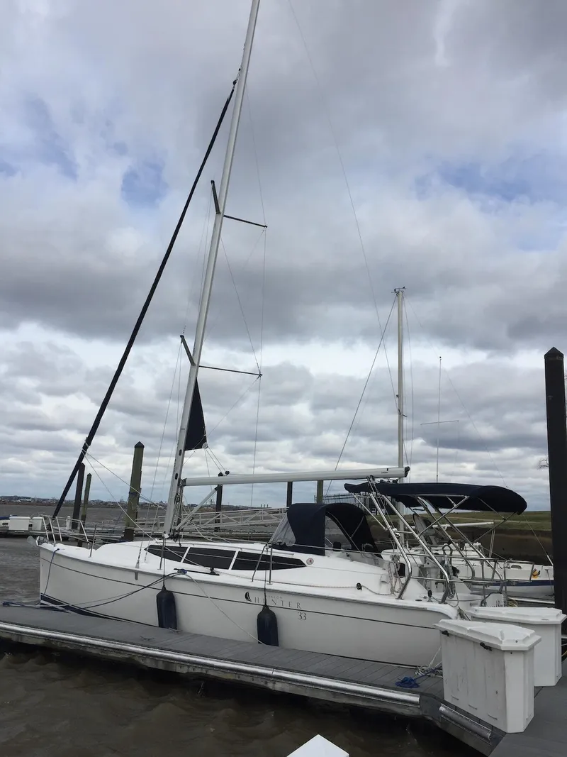 The Image of 2014 Marlow-Hunter e33 sailboat docked under cloudy skies. - 0