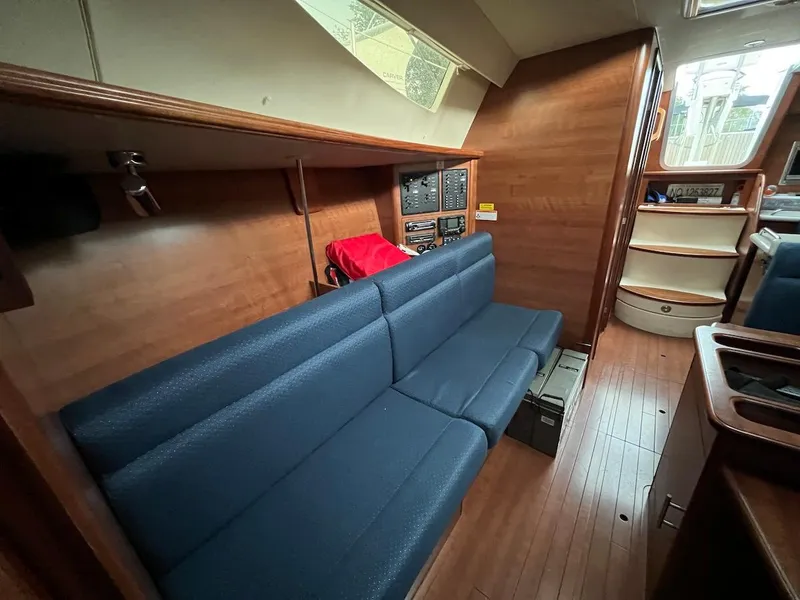 Slide: The Image of 2014 Marlow-Hunter e33 interior with blue seating and wooden finishes. - 11