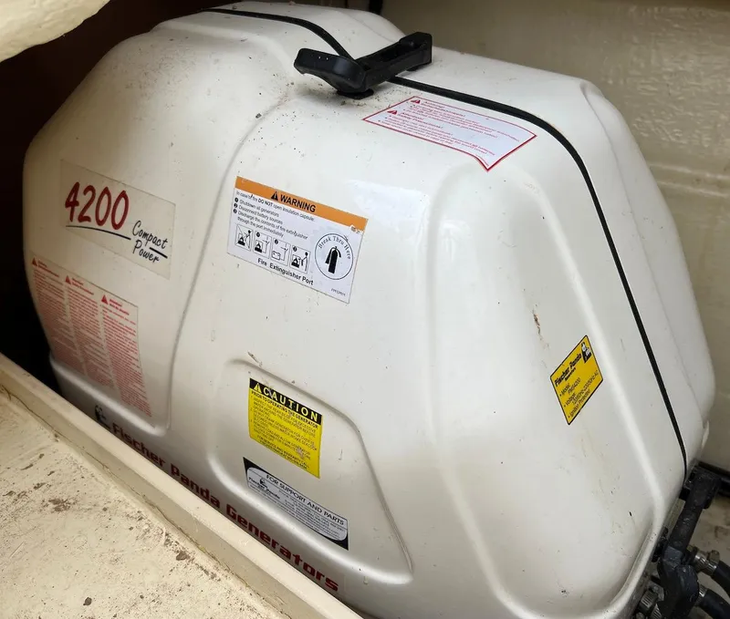 Slide: The Image of 2014 Marlow-Hunter e33 boat generator, model 4200, compact power unit in storage compartment. - 16