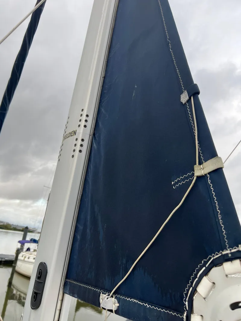 Slide: The Image of 2014 Marlow-Hunter e33 sailboat mast and sail detail at marina. - 6